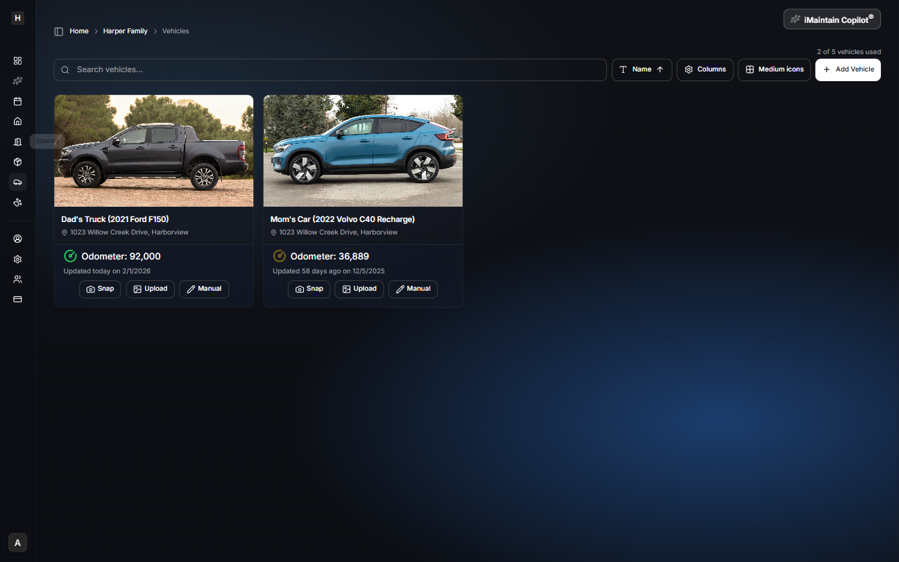 Vehicles card view showing vehicle cards with photos, names, and odometer values with an Add Vehicle button