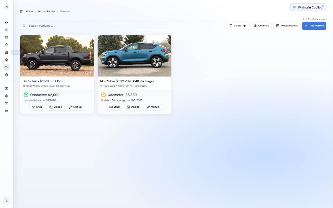 Vehicles card view showing vehicle cards with photos, names, and odometer values with an Add Vehicle button