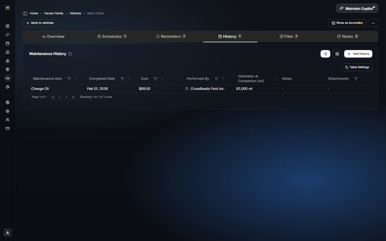 Vehicle details page on the History tab showing maintenance history entries with completed date, cost, performed by, and odometer at completion