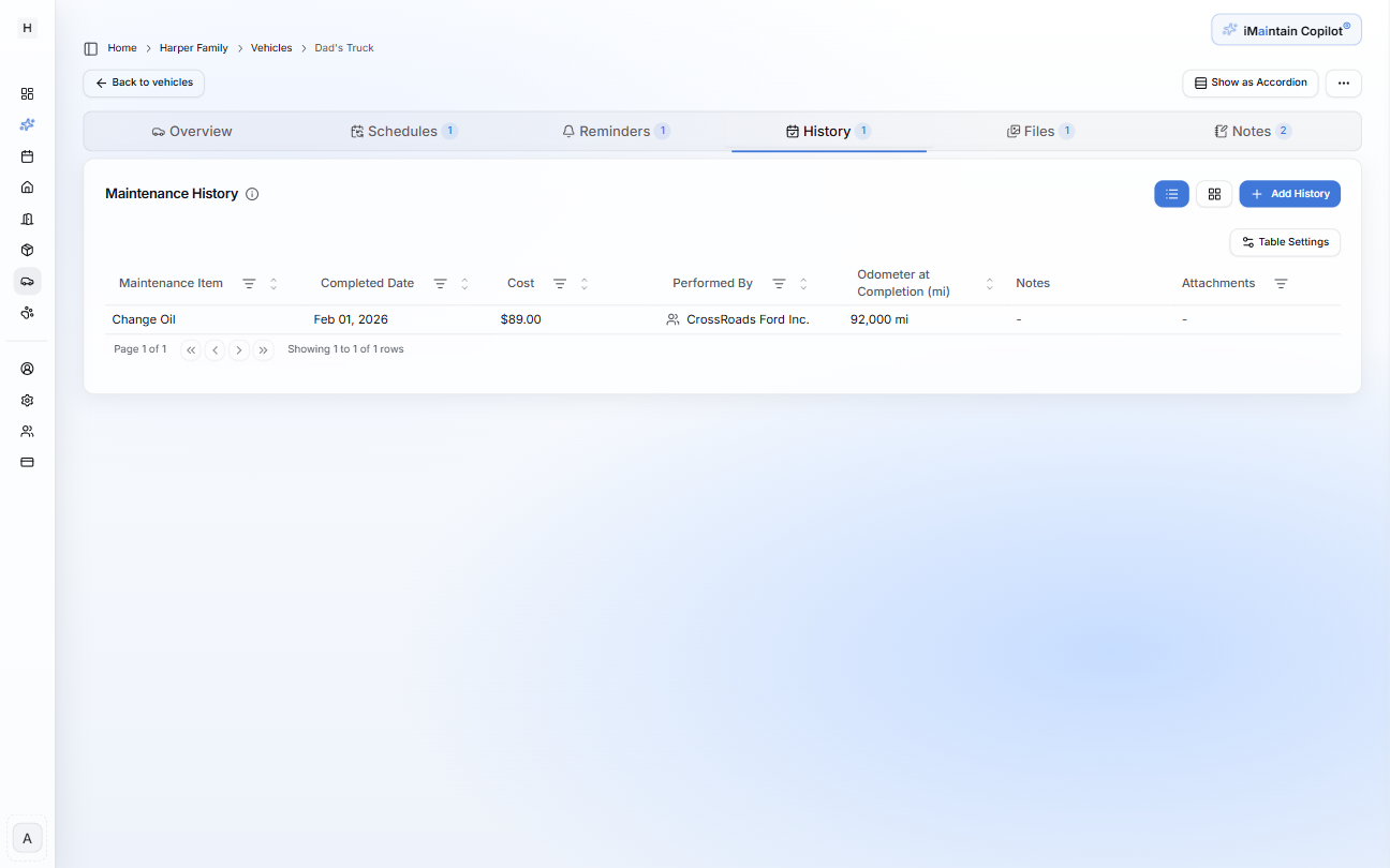 Vehicle details page on the History tab showing maintenance history entries with completed date, cost, performed by, and odometer at completion